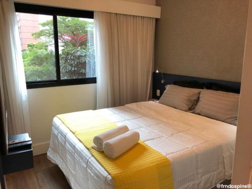 a bedroom with a bed with two towels on it at Apartamento confortável - Itaim Bibi in Sao Paulo