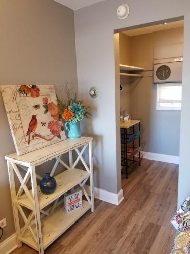 a room with a table and a shelf with flowers on it at Gateway Inn in Chicago