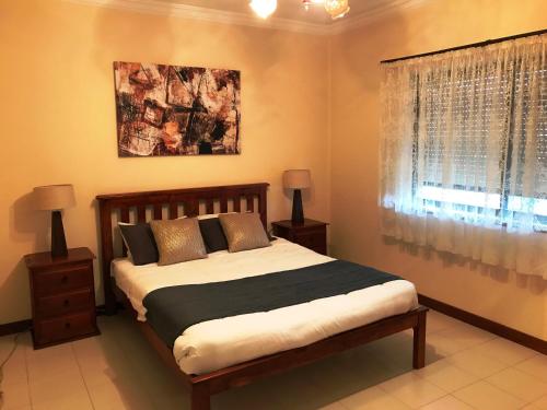 a bedroom with a large bed and a window at Adelaide's holiday home in Modbury