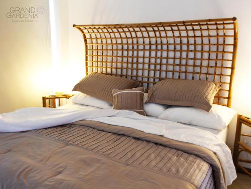 a bed with pillows on top of it at Grand Gardenia in Atlixco