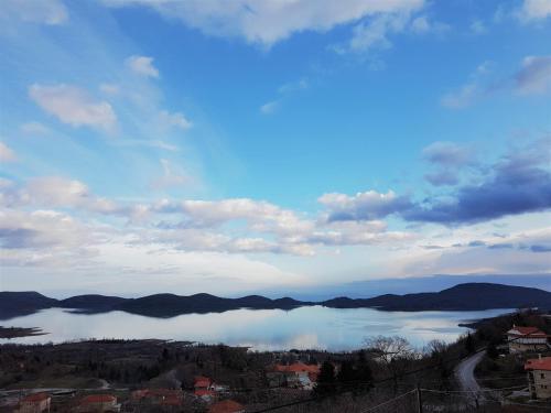 a view of a lake with mountains in the distance at Archontiko Zakoni in Neochori