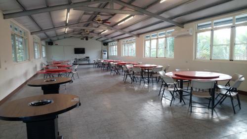 a large room with tables and chairs and windows at Cishan San-Ho-Yuan in Qishan