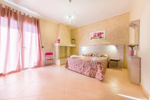 a bedroom with a bed and a large window at B&B Rosso Salento in Alliste