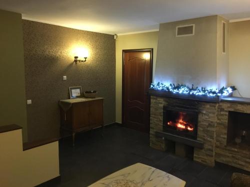 a living room with a fireplace with blue christmas lights at Lee Apartments in Tallinn