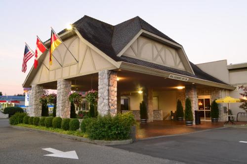 a building with flags on the front of it at The Hospitality Inn in Port Alberni