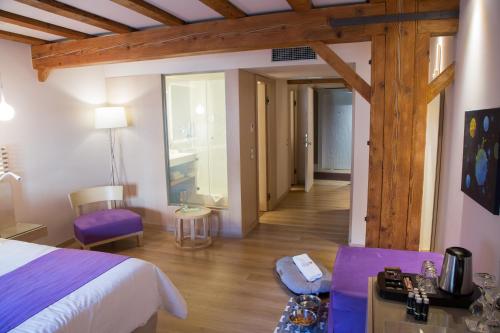 a bedroom with a bed and a living room at Hydrama Grand Hotel in Drama