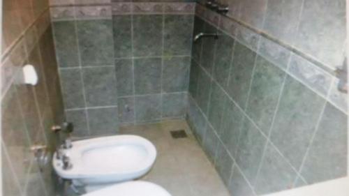 a bathroom with a white toilet and a sink at Chapadmalal Casas La Bella in Colonia Chapadmalal