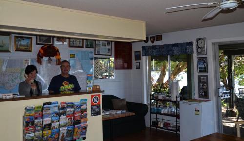 a man and a woman standing in front of a store at Tweed River Motel in Murwillumbah