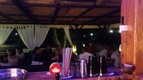 a group of people sitting at a table in a restaurant at Apartmani Premijer-Rab in Supetarska Draga