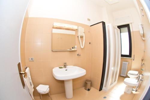 a bathroom with a sink and a mirror at Hotel Milano in Pistoia