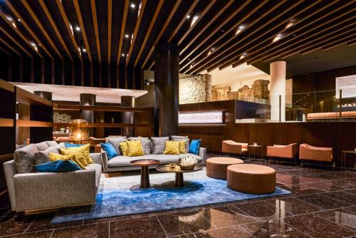 a lobby with a couch and a table and chairs at Áurea Museum by Eurostars Hotel Company in Lisbon