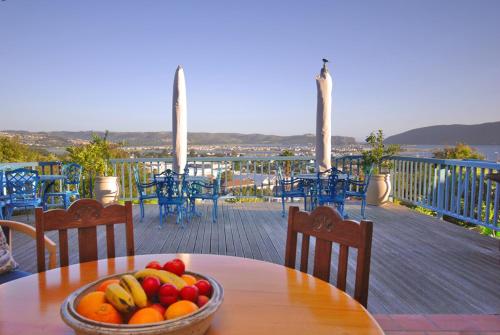 a bowl of fruit on a table on a deck at Guinea Fowl Lodge in Knysna