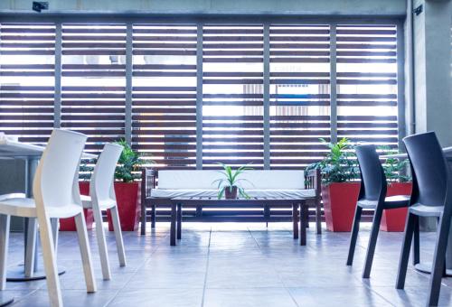 a table and chairs in front of a large window at Circus Hostel in Buenos Aires
