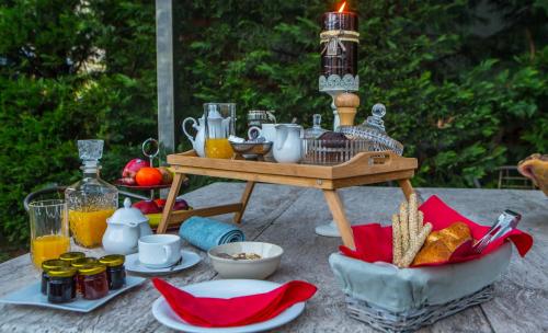 a picnic table with a bird cage and a basket of food at Morfeas Guesthouse in Kato Loutraki