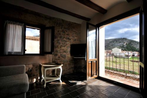 a room with a large sliding glass door with a view at La Casa Grande de Albarracín in Albarracín