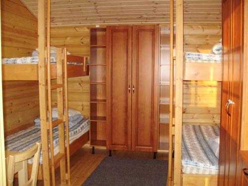 a cabin with three bunk beds in it at Pohjanranta Cottages in Keminmaa