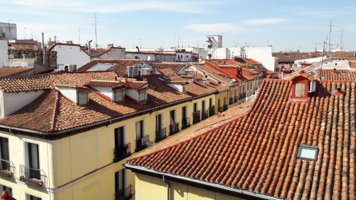 a view of roofs of buildings in a city at Hostal Casa Chueca in Madrid