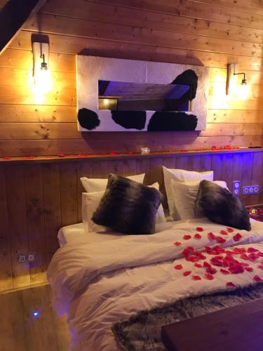 a bedroom with a bed with roses on it at Le Chalet Loft and Spa in Villeurbanne