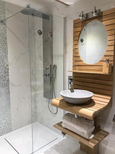 a bathroom with a sink and a shower at Le Chalet Loft and Spa in Villeurbanne