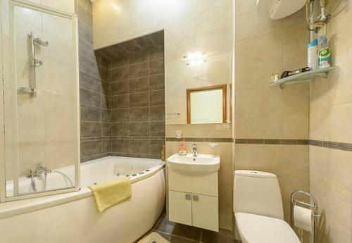 a bathroom with a tub and a toilet and a sink at квартира in Kyiv