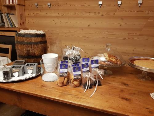 a table with bread and other food on it at Hotel Pedretti in Branzi