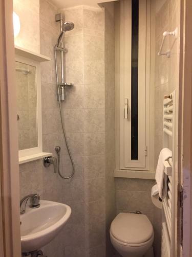 a bathroom with a toilet and a sink at Varese Guest House in Rome