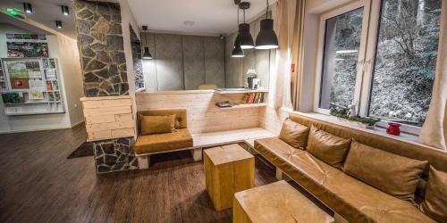 a living room with a couch and a table at Riverside in Demanovska Dolina