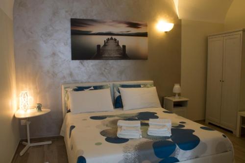 a bedroom with a bed with two towels on it at Welcome Dimora in Polignano a Mare