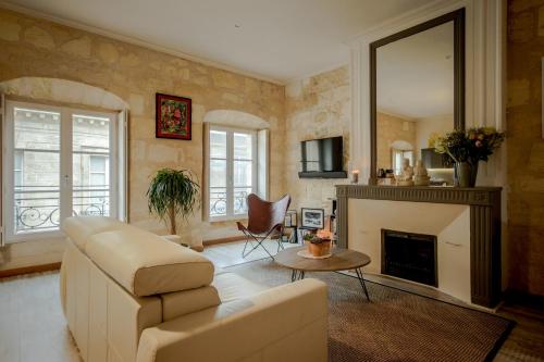 a living room with a couch and a fireplace at Nona Home Bordeaux in Bordeaux