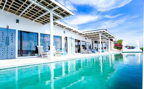 a villa with a swimming pool and a house at Amatoa Resort in Bira