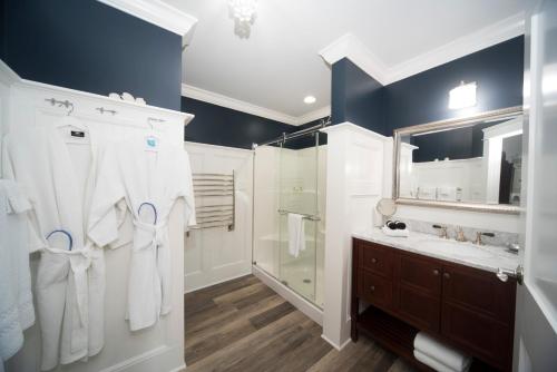a bathroom with a shower and a sink and a mirror at Anchor Inn Boutique Hotel in Put-in-Bay
