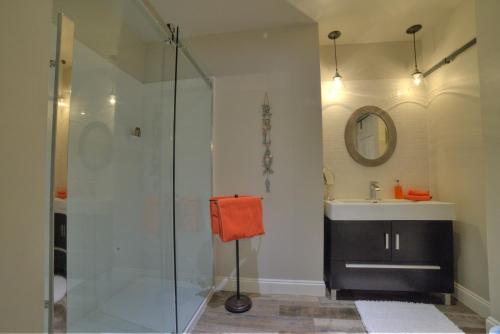 a bathroom with a shower and a sink at Shawnigan Suite B & B in Shawnigan Lake