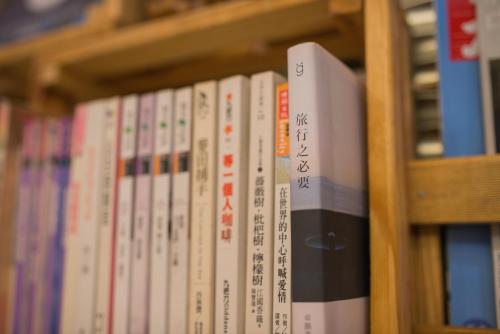 a row of books on a book shelf at Green Park Homestay in Luodong