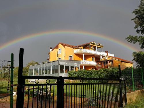 a rainbow over a house with at Apartments Šeherzada in Pula