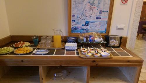 a breakfast table with food and drinks on it at Aurora Villa in Renai