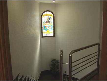 a stairway with a stained glass window and a stair railing at Hostal Jalisco in Ajofrín