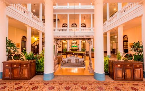 an indoor lobby of a building with columns at Royal Orchid Brindavan Garden Mysore in Belagula