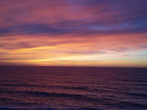 a sunset over the ocean with the sky at Apartment Moe More in Odesa