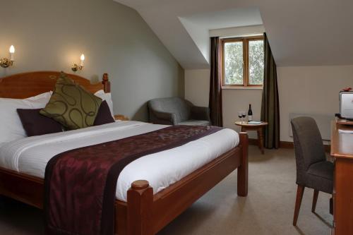 a hotel room with a bed and a tv at Garstang Country Hotel & Golf, Sure Hotel Collection in Garstang