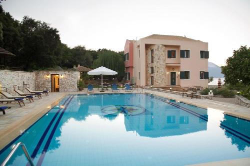 a large swimming pool in front of a building at Ionian Queen Villa in Dhikhália