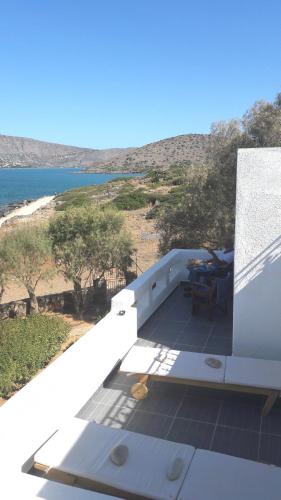 a balcony of a house with a view of the ocean at Elounda Island Villas in Elounda