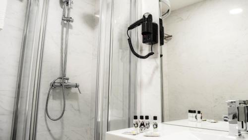 a bathroom with a shower and a sink at Bairro Alto Suites in Lisbon