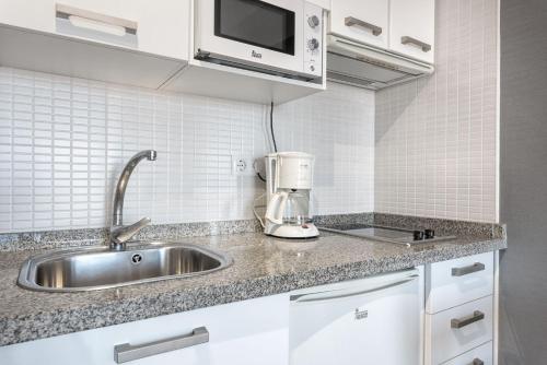 a kitchen with a sink and a coffee maker at Solaga - Susana in Málaga
