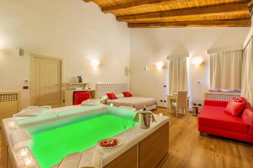 a living room with a large pool in the middle of a room at Hotel Sa Cheya Relais & Spa in Alghero