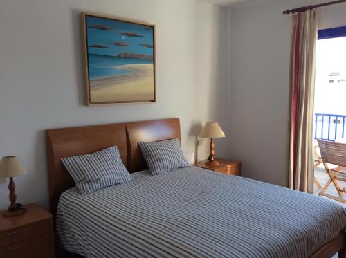 プラヤ・ブランカにあるVilla Anclazul Marina Rubiconのベッドルーム1室(青と白のストライプの掛け布団付きのベッド1台付)