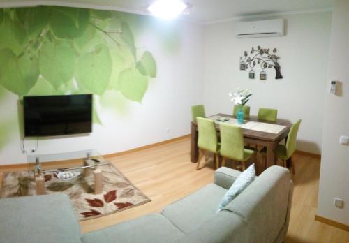 a living room with a couch and a table at Birds House - Village Marina in Olhão