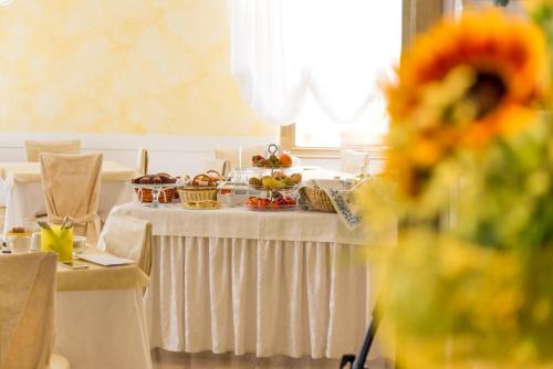 a table with dishes of food on top of it at Hotel St. Moritz in Rimini