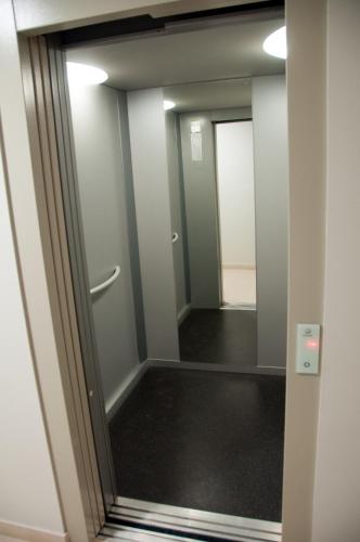 a hallway of an office with a glass door at Birds House - Village Marina in Olhão