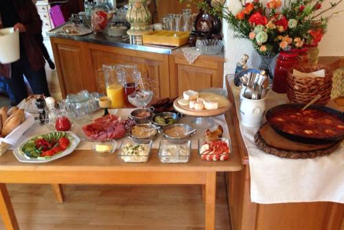 a table with many different food items on it at BE ME Black Forest Family Apartment -Zum Letzten G'Stehr in Bad Rippoldsau