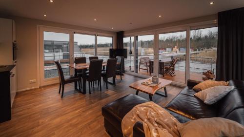 a living room with a couch and a table at Goitzsche Resort in Bitterfeld